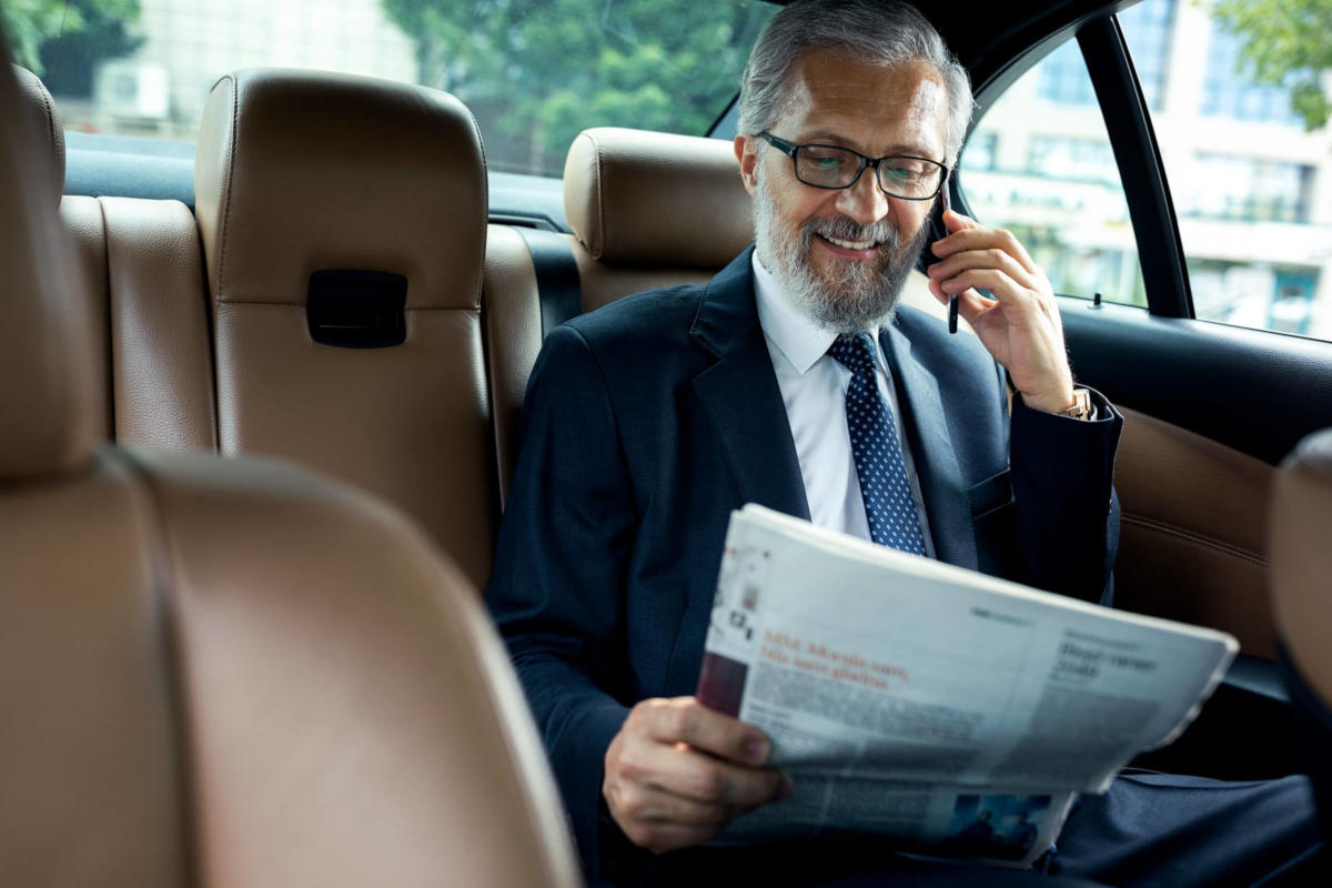 Executive corporate chauffeur car in front of a London office building